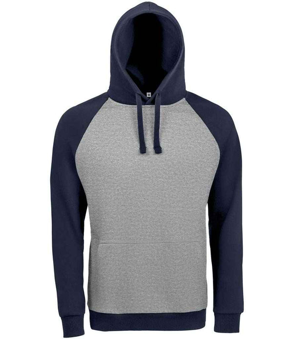 The SOLS Unisex Seattle Contrast Raglan Hoodie features a light gray front with navy blue raglan sleeves, hood, and waistband. It includes a lined hood, kangaroo pocket, and drawstrings for comfort and style.