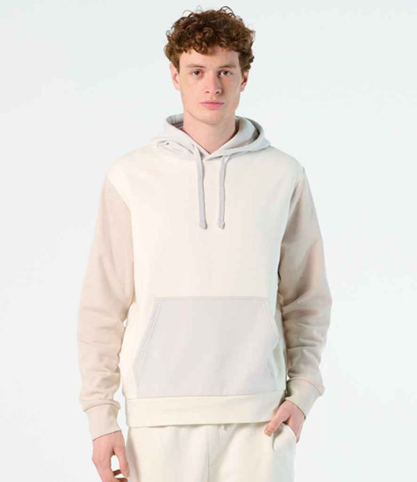 A young man with curly hair wears the SOLS Unisex Collins Organic Contrast Hoodie, featuring a lined hood and front pocket. He stands against a plain, light background, looking directly at the camera.