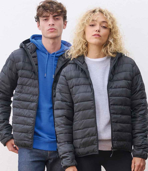 A young man and woman stand side by side wearing black SOL’S jackets. The woman wears the SOL’S Ladies Stream Hooded Jacket over a light grey sweatshirt, while the man pairs his jacket with a blue hoodie. Both face the camera against a plain backdrop.