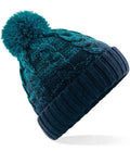The Beechfield Ombré Pom Pom Beanie by Beechfield features blue and teal hues, a classic cable knit design, folded ribbed brim, and a large pom-pom on top.