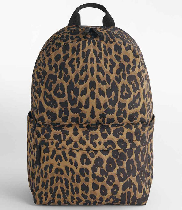 The BagBase Leopard Print Backpack by BagBase features brown and black tones, padded shoulder straps, a front zipper pocket, top carry handle, and a laptop slip pocket—all shown on a plain white background.