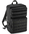 The BagBase MOLLE Tactical Backpack by BagBase is black, made from recycled polyester, and features multiple zippered compartments, adjustable shoulder straps, military-style webbing for gear attachment, and a top carry handle.