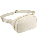 The BagBase Sundae Cross Body Bag by BagBase is a beige fanny pack with premium fabric, a zippered main compartment, adjustable webbing strap, and gold-tone zipper hardware, shown on a white background.