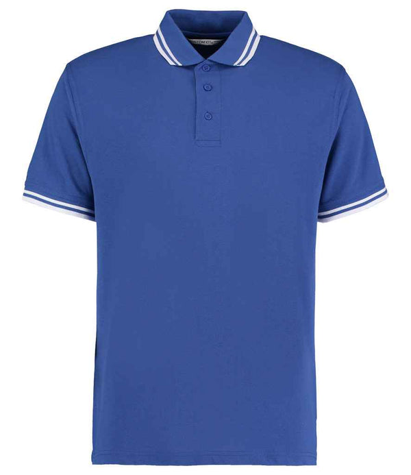 The Kustom Kit Contrast Tipped Poly/Cotton Piqué Polo Shirt is a blue short-sleeve classic fit shirt with a ribbed collar and sleeve cuffs featuring white double stripes, three-button placket, and plain front. Brand: Kustom Kit.