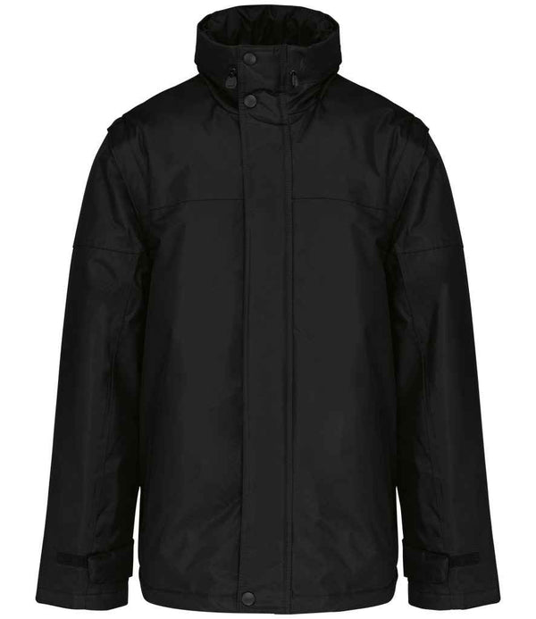 The Kariban Factory Zip Off Sleeve Jacket by Kariban is a black showerproof winter jacket with long sleeves, a high collar, polyester padding, flap-covered front zipper with snap buttons, two side pockets, and weather-resistant material.