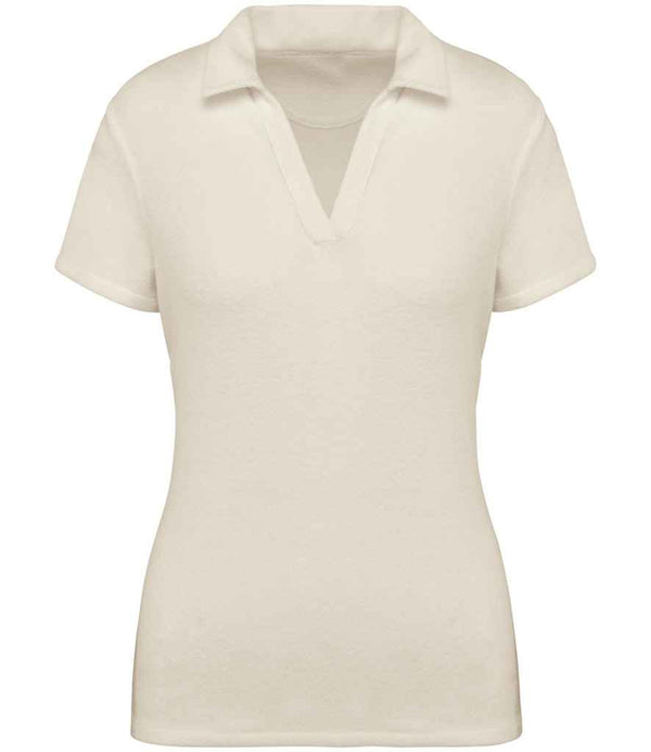 The Native Spirit Ladies Terry Towel Polo Shirt is a cream-colored, short-sleeved women’s polo with a V-neck collar, made from enzyme washed recycled polyester, shown against a white background.