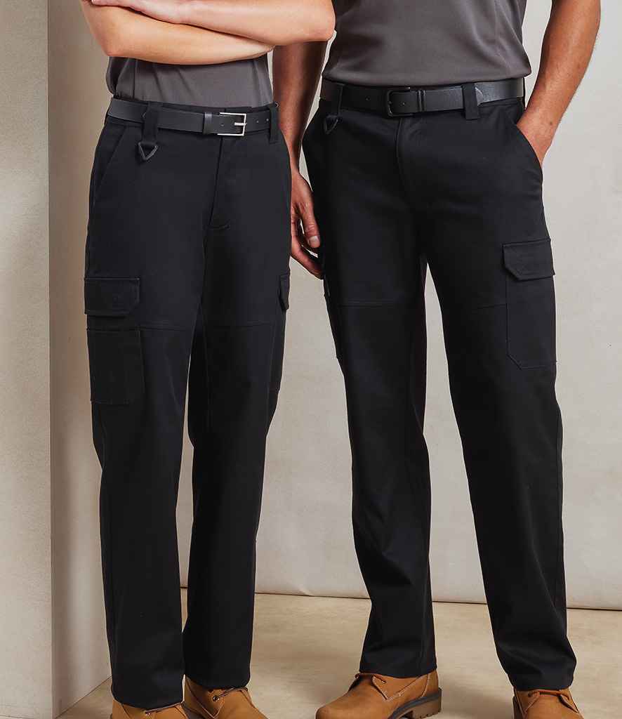 Two people stand side by side, each wearing Premier Unisex Stretchchecker Work Cargo Trousers with black belts, gray shirts, and tan work boots. Their upper bodies are partly out of frame against a plain, light-colored background.