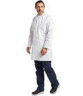 A man with short brown hair and a beard wears a white Portwest Lab Coat over a white shirt and navy pants, paired with black sneakers. He stands against a plain white background, looking slightly to the side.