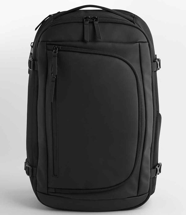 The Quadra Zurich Travel Backpack by Quadra is a modern 30L backpack with a minimalist design, multiple compartments, zippers, a padded laptop section, top handle, and adjustable shoulder straps. It stands upright against a plain background.