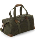 The Quadra Heritage Waxed Canvas Holdall by Quadra features green canvas, brown leather trim, cotton webbing handles with a leather grip, an adjustable shoulder strap, and multiple zippered compartments.