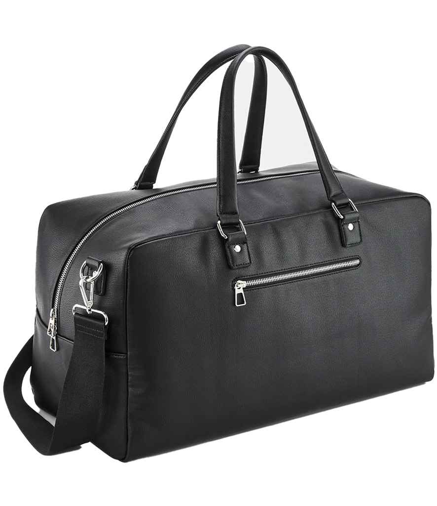 The Quadra Tailored Luxe Weekender by Quadra is a black leather duffel with silver zippers, two handles, and an adjustable shoulder strap. Made from recycled polyester, it has a zip front pocket and a roomy 25L main compartment.