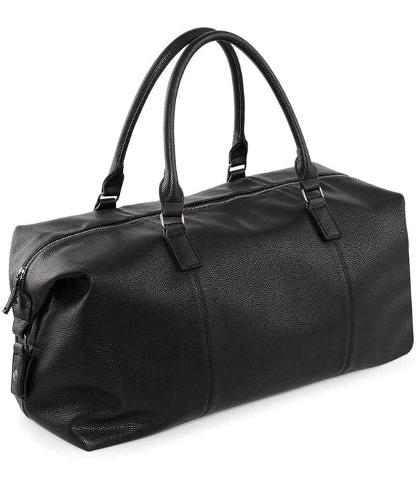 The Quadra NuHide® Weekender by Quadra is a black leather duffel bag with carry/shoulder handles, silver hardware, a side zip pocket, textured surface, main zip compartment, and 30L capacity, shown against a white background.