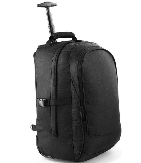 The Quadra Vessel™ Airporter by Quadra is a black, soft-sided rolling suitcase with a retractable handle, several zippered compartments, a side buckle strap, and durable skate wheels, shown against a plain white background.