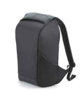 The Quadra Project Charge Security Backpack by Quadra is black with a minimalist look, padded straps, a laptop compartment, and side pocket. It stands upright on a plain white background.