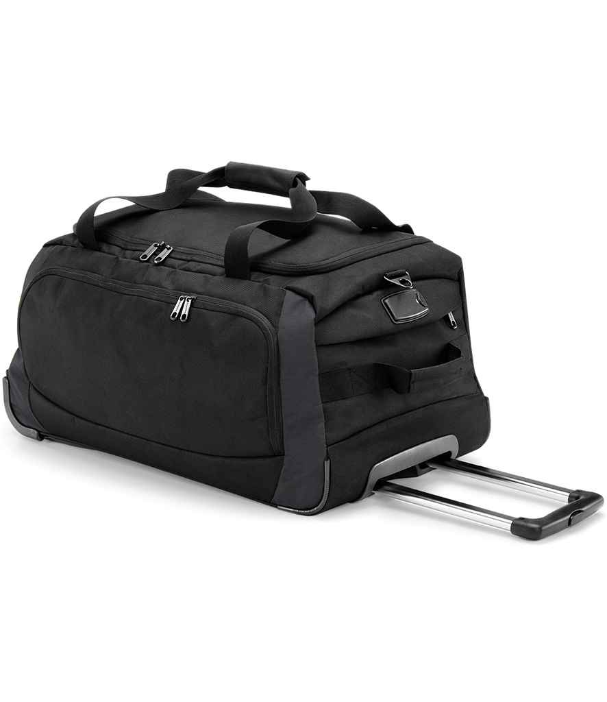 The Quadra Tungsten™ Wheelie Travel Bag by Quadra is a black rolling duffel with multiple zippered compartments, padded top handles, an extended telescopic pull handle, reinforced corners, and durable skate wheels for smooth transport.
