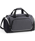 The Quadra Pro Team Locker Bag by Quadra is a gray and black rectangular sports gym bag featuring two short handles, an adjustable shoulder strap, multiple zip compartments, a shoe tunnel, and white trim for added style.