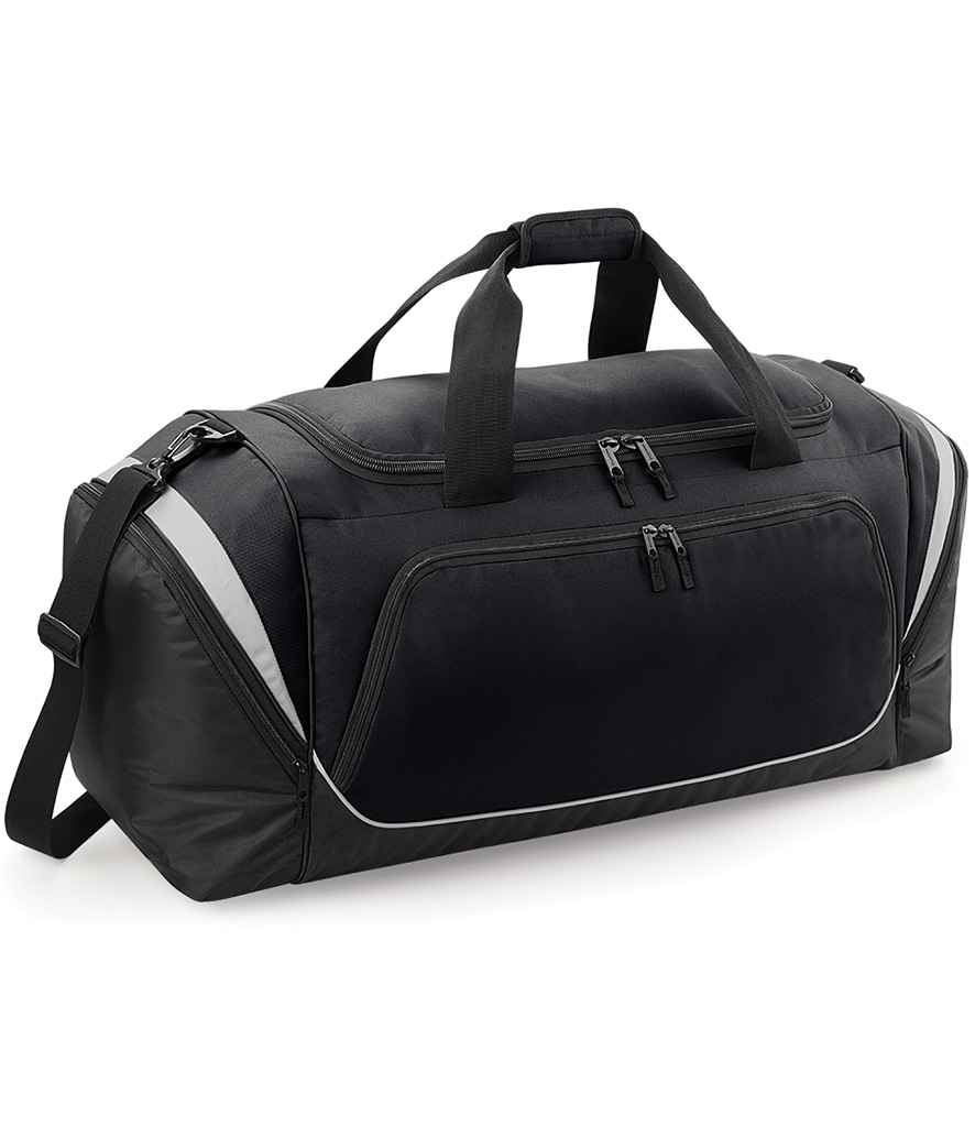 The Quadra Pro Team Jumbo Kit Bag by Quadra is a black and gray duffel made from recycled polyester, with a large main compartment, front zippered pocket, side pockets, double handles, and an adjustable shoulder strap.