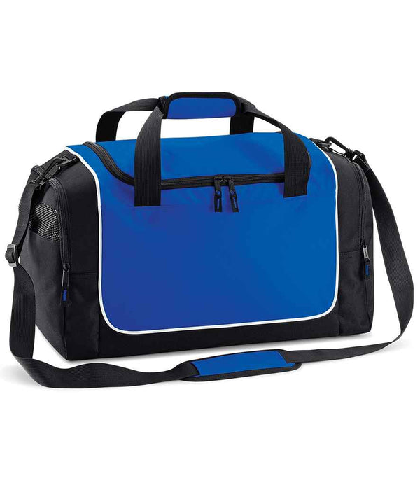 The Quadra Teamwear Locker Bag by Quadra features blue and black design, black handles, adjustable shoulder strap, front zip pocket, mesh side pocket, and white piping—ideal as a compact gym bag.
