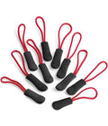 The Quadra SLX Puller Pack by Quadra includes ten black zipper pulls with non-slip textured grips and red cord loops, all arranged on a white background and designed for everyday durability.