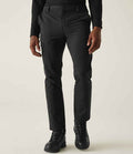 A person models the Regatta Pro Action Stretch Trousers by Regatta Professional, paired with a long-sleeve black shirt and boots. Cropped at the upper chest, the image focuses on the lower body against a plain light background.