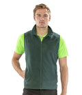 A person faces forward, wearing the Result Core Micro Fleece Gilet in green from Result Core over a bright green short-sleeve polo and black pants, with one hand in the gilet pocket.