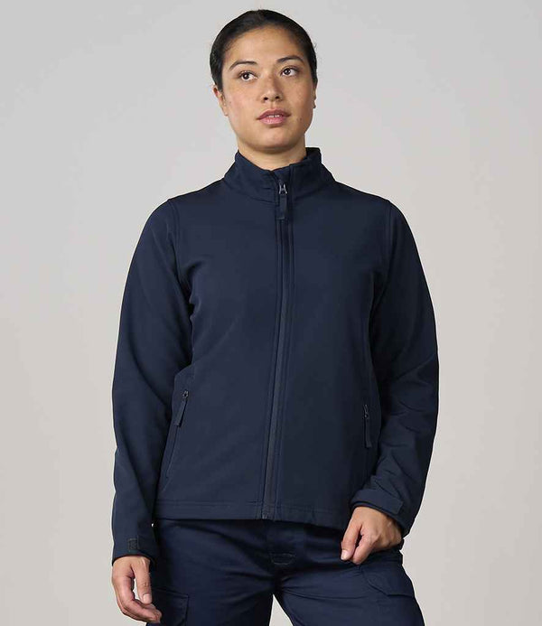 A person with dark hair pulled back is wearing the Pro RTX Ladies Pro Two Layer Soft Shell Jacket by Pro RTX, a navy blue windproof zip-up with a high collar, standing against a plain light gray background.