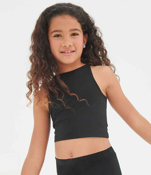 A young girl with long, curly brown hair wears the SF Clothing Kids Cropped Top by SF Clothing with black bottoms, standing against a plain white background and smiling slightly at the camera.