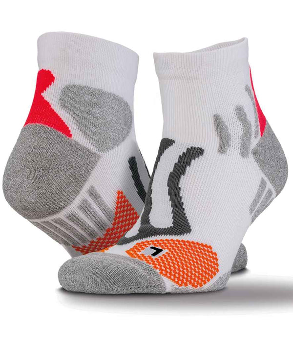 Spiro Technical Compression Sports Socks by Spiro are white ankle socks with gray, orange, and red cushioned zones and black lines. Made with Coolmax fabric for quick drying, they offer reinforced toes, heels, and built-in arch support for athletes.