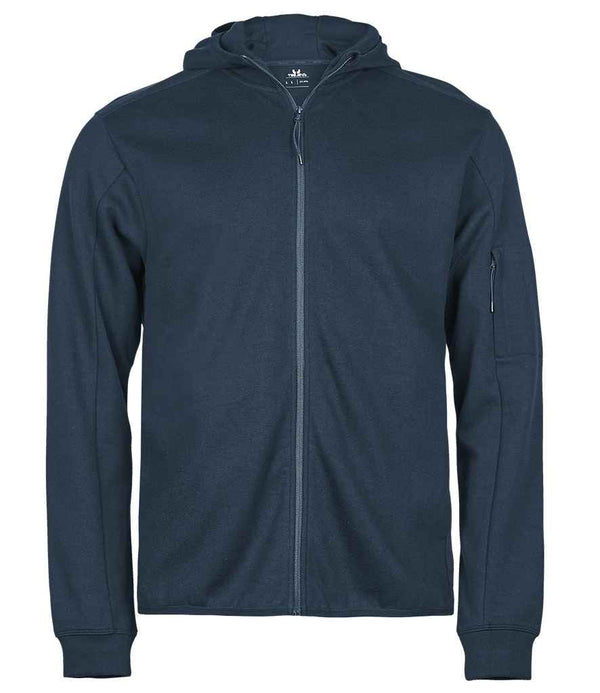 The Tee Jays Athletic Hooded Full Zip Sweat Jacket by Tee Jays is a navy blue, organic cotton fleece hoodie with a hood, long sleeves, front zipper, and a small zip pocket on the left sleeve, shown against a white background.