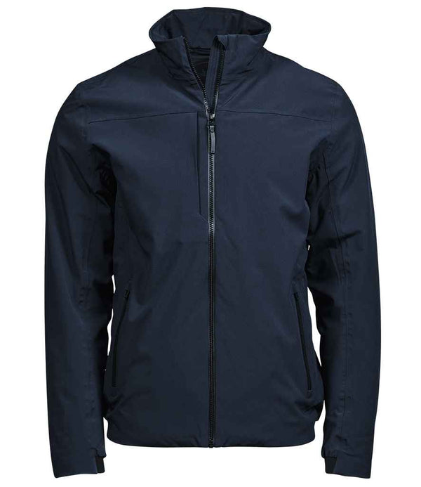 The Tee Jays All Weather Jacket by Tee Jays is a dark navy zip-up with a high collar, long sleeves, two side pockets, and a chest pocket with vertical zipper. Made from recycled polyester, this fitted jacket blends style and function.