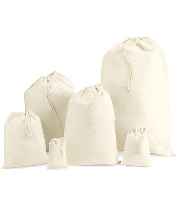 Six Westford Mill Cotton Stuff Bags by Westford Mill, in assorted sizes, stand upright against a white background. Each off-white bag has a strong rope drawcord closure and is crafted from cotton fabric.