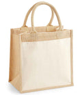 The Westford Mill Pocket Jute Midi Tote Bag by Westford Mill is a beige cotton canvas tote with sturdy jute sides, cotton handles, a large cream front pocket, and 14L capacity. It stands upright on a white background.