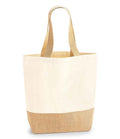 The Westford Mill Jute Base Canvas Shopper features a two-tone design with an off-white upper, light brown jute base, beige cotton webbing straps, and premium heavyweight fabric. It stands upright on a plain white background.