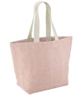The Westford Mill Soft Washed Jute Beach Bag by Westford Mill is a light pink tote with off-white webbing shoulder straps, an unadorned design, and an internal slip pocket, shown standing upright against a plain white background.