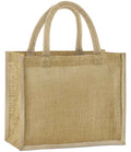 The Westford Mill Natural Starched Jute Midi Tote Bag is a plain, rectangular tote with reinforced seams, cotton handles, and a coarse woven texture. Light brown and unadorned, it offers a roomy 14L capacity. Brand: Westford Mill.