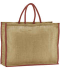 The Westford Mill Natural Starched Jute Market Shopper, a rectangular tan tote bag with sturdy cotton handles and maroon edge trim, featuring a cut-out label, stands upright against a white background.