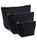 Three Westford Mill Canvas Accessory Bags by Westford Mill in different sizes stand upright in a staggered row against a white background, each featuring a visible metal zip closure at the top.