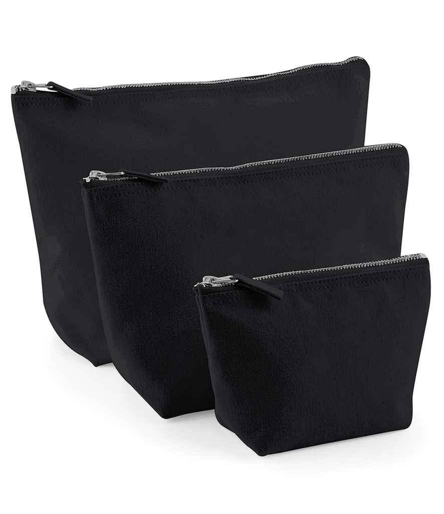 Three Westford Mill Canvas Accessory Bags by Westford Mill in different sizes stand upright in a staggered row against a white background, each featuring a visible metal zip closure at the top.