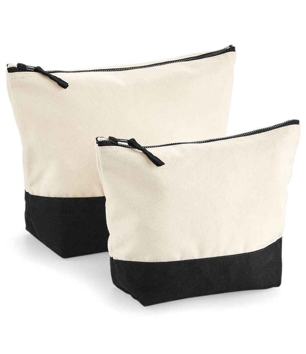 The Westford Mill Dipped Base Accessory Bags by Westford Mill are two canvas zipper pouches with a cream top and black base, standing upright. Both have secure zip closures and versatile uses; one pouch is larger than the other.