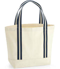 The Westford Mill EarthAware® Organic Boat Bag is a heavyweight, off-white canvas tote with dark blue striped cotton webbing handles, a square base, 19L capacity, and stands upright. Brand: Westford Mill.