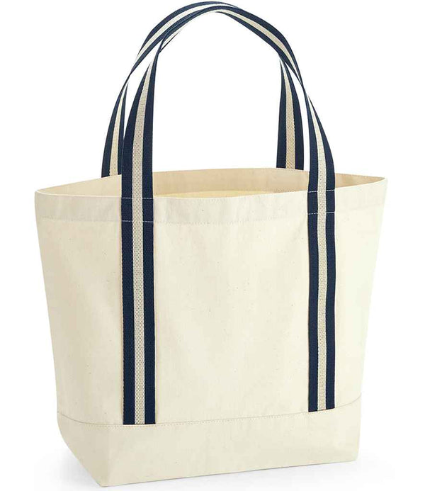 The Westford Mill EarthAware® Organic Boat Bag is a heavyweight, off-white canvas tote with dark blue striped cotton webbing handles, a square base, 19L capacity, and stands upright. Brand: Westford Mill.