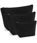 Three Westford Mill EarthAware® Organic Accessory Bags, in black and varying sizes, stand upright in front of each other against a white background. Crafted from premium heavyweight fabric by Westford Mill.