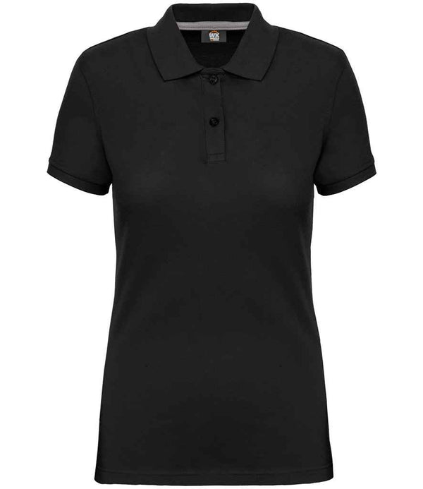 The WK Designed to Work Ladies Anti-Bacterial Piqué Polo Shirt features a plain black, short-sleeve design with a ribbed collar and two-button placket, made from soft pique knit fabric and shown against a white background.